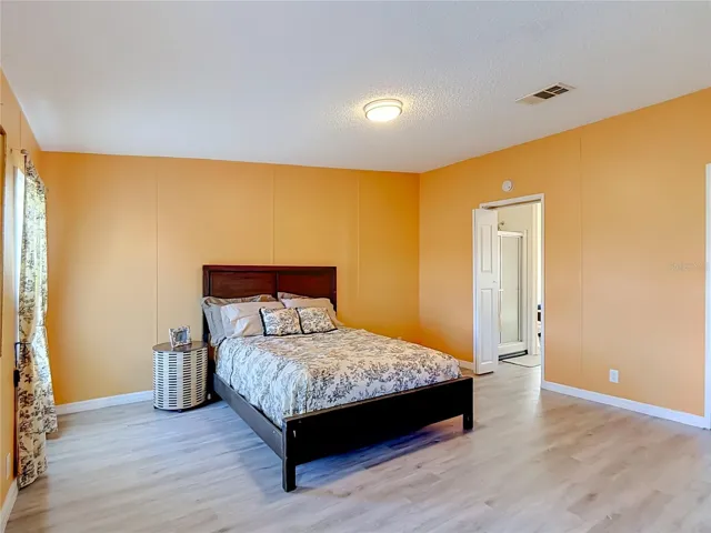 Primary bedroom with doorway leading to the primary bathroom.