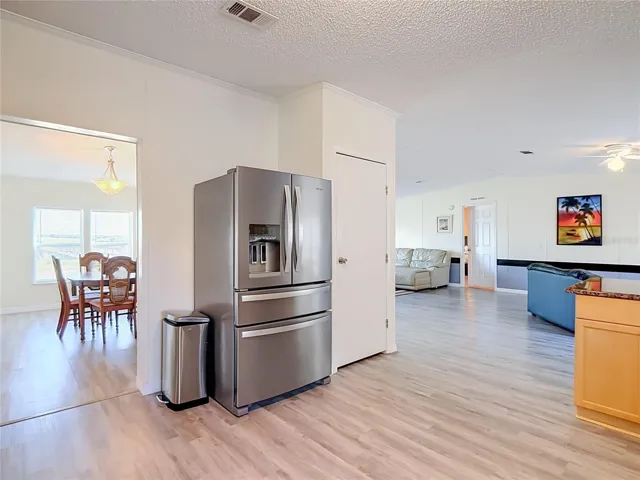Stainless steel appliances and food pantry.  This picture shows the open floorpan looking from the kitchen you can see the dining room to your left and living room to your right.