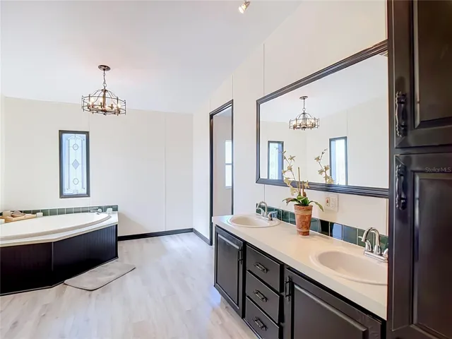 Primary bathroom has a garden tub, dual sinks with plenty of storage.