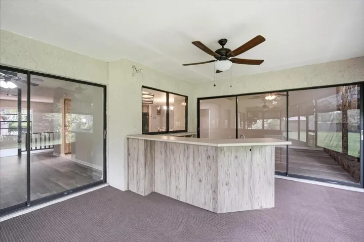 Massive outdoor covered, screened lanai with outdoor kitchen and ceiling fans