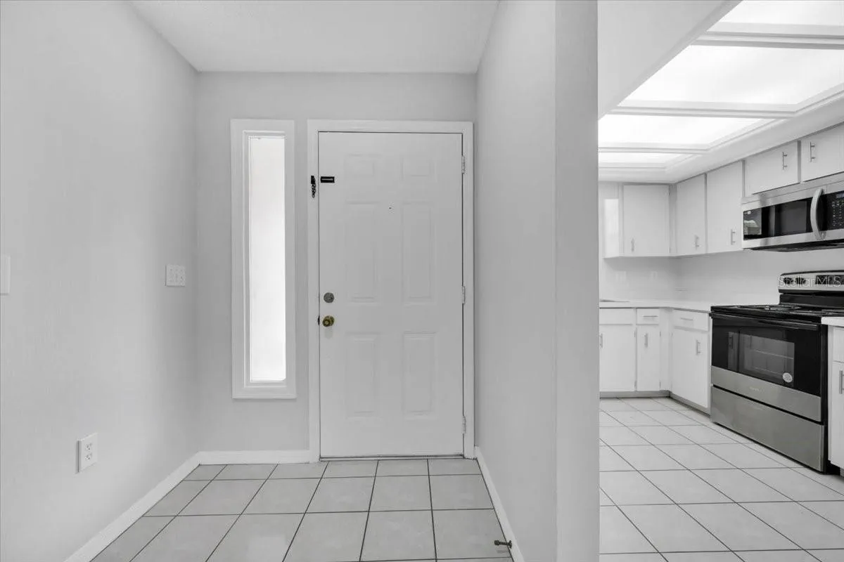 Looking at the front door after you enter with a kitchen view on your right