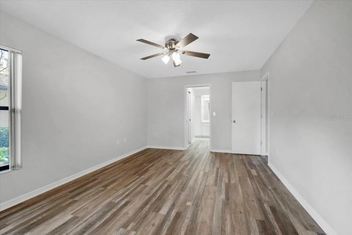 Looking at the entry to the front bedroom with new flooring and paint