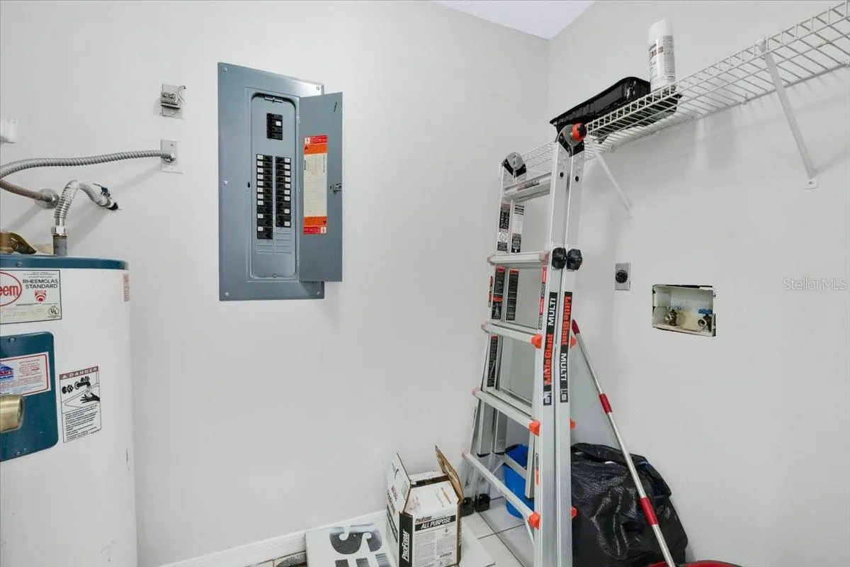 the indoor laundry room which contains the electric hot water heater and the air handler