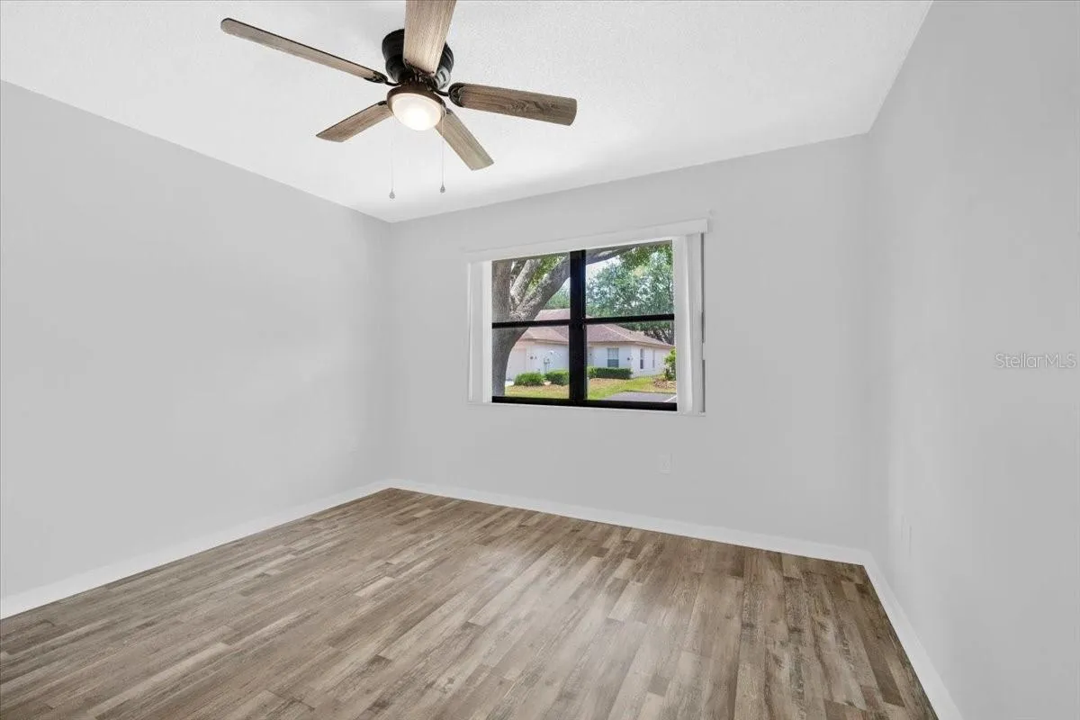 Looking into the front bedroom with new flooring and paint