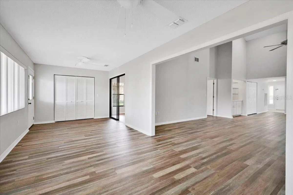 From the flex room looking into the great room on the right and the sliding glass door to the primary bedroom ahead