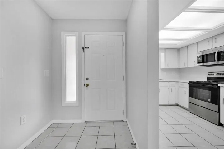 Looking at the front door after you enter with a kitchen view on your right