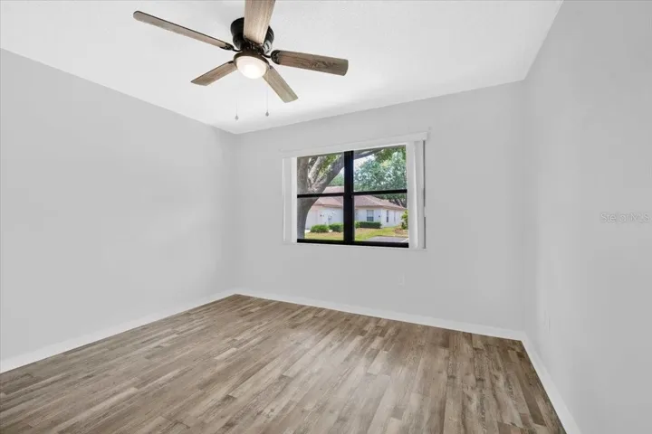 Looking into the front bedroom with new flooring and paint