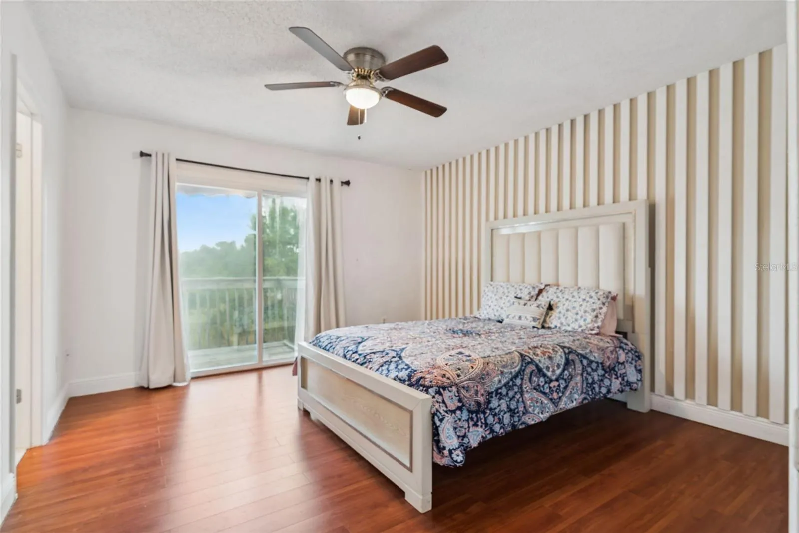 Primary Bedroom with view to Balcony and Pond