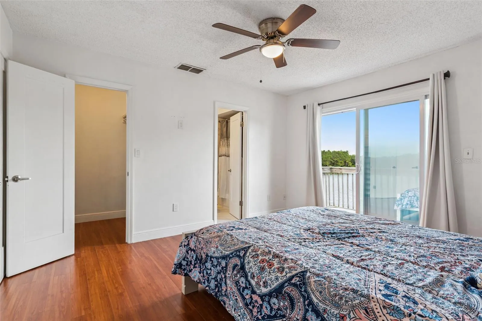Primary Bedroom with walk-in closet, Ensuite and view to pond