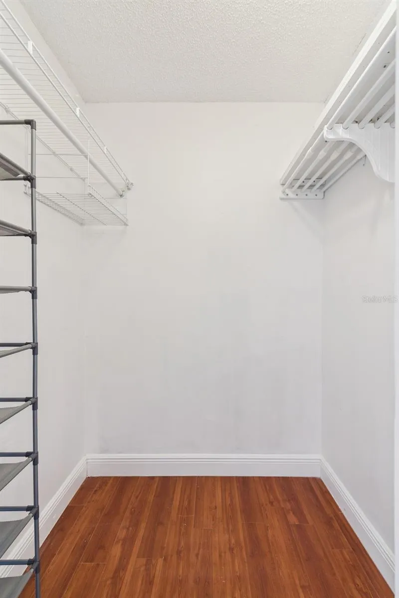 Primary bedroom walk-in closet