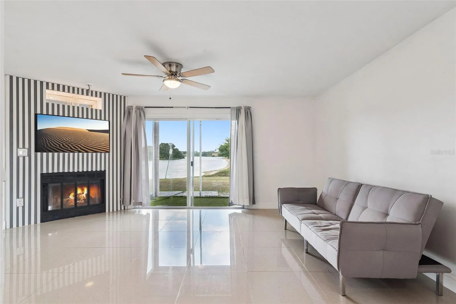 Living Room featuring fireplace with view to covered patio