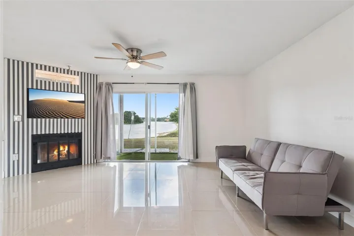 Living Room featuring fireplace with view to covered patio