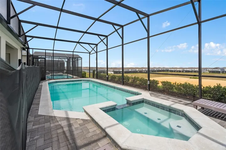 screened in pool with spa