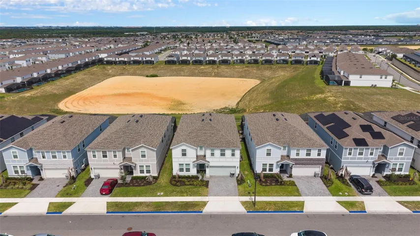 rear of home has no rear neighbor and looks over dry retention pond