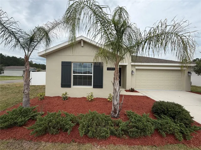 Front exterior view of this corner lot home, showcasing professional landscaping and elegant architectural curb appeal.