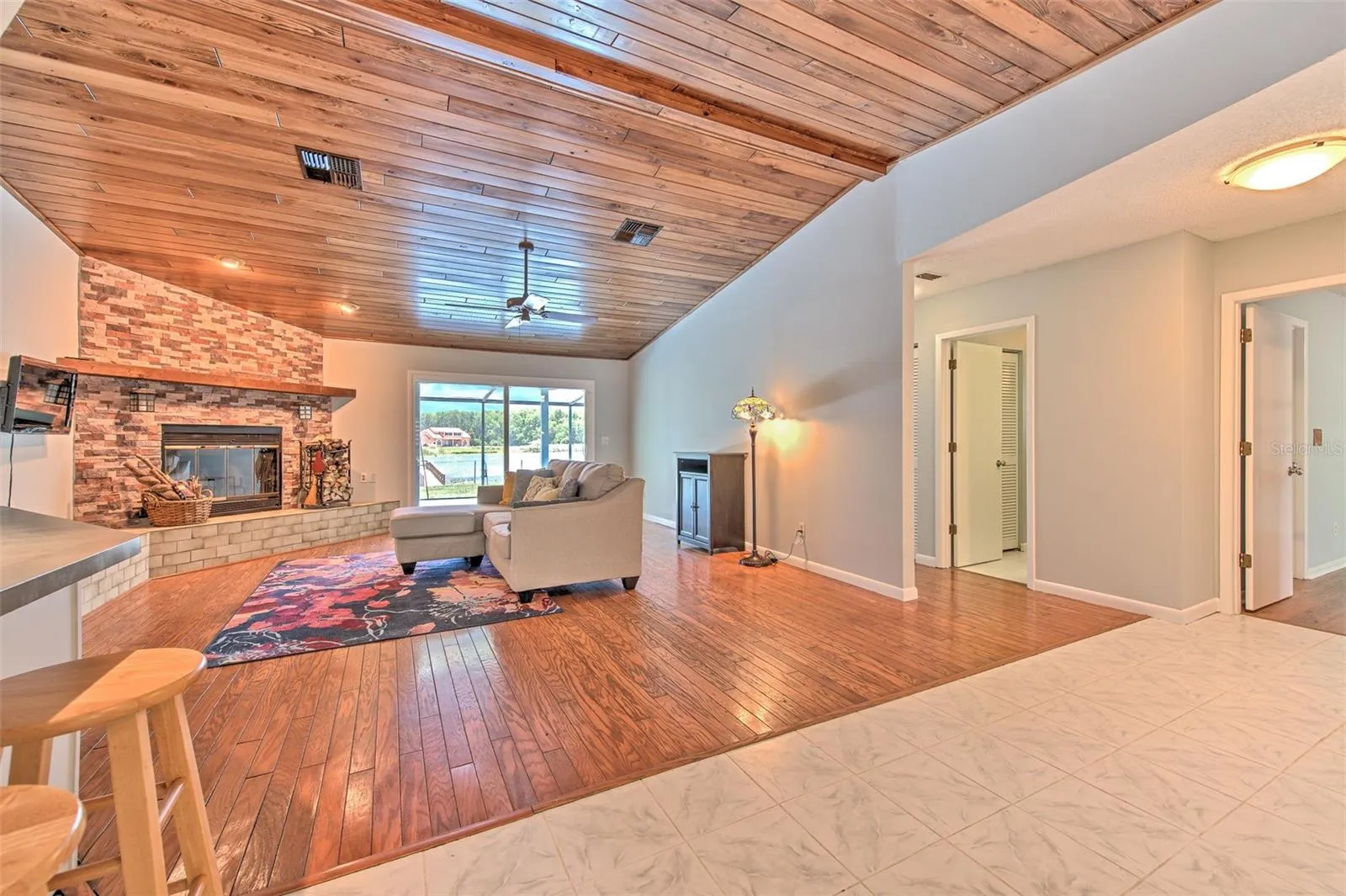 Open concept floor plan. tongue & groove living room ceilings, wood burning fireplace