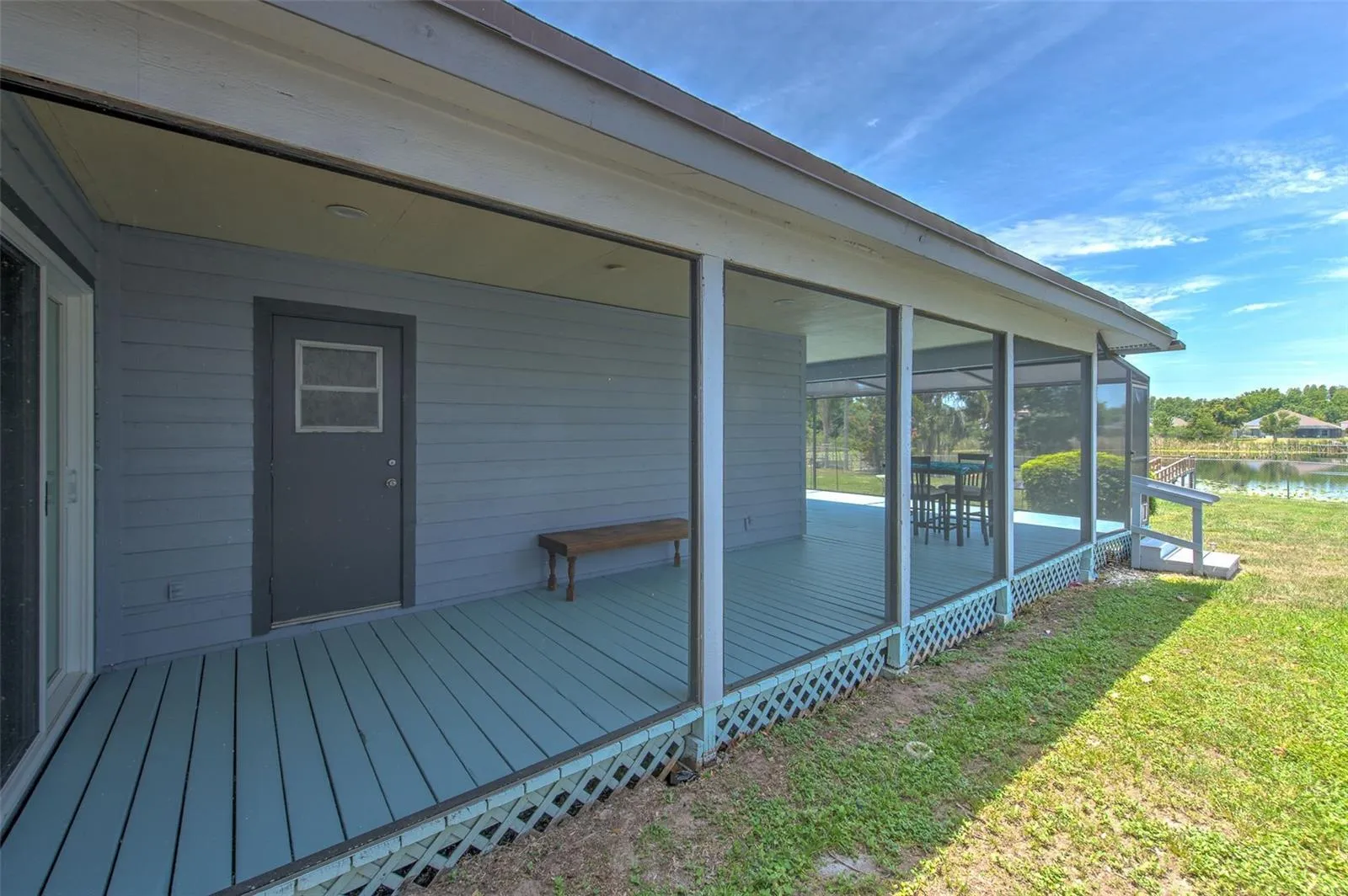 Wrap around covered screened in patio (view of slider door at bedroom 2 and bathroom 2 door)