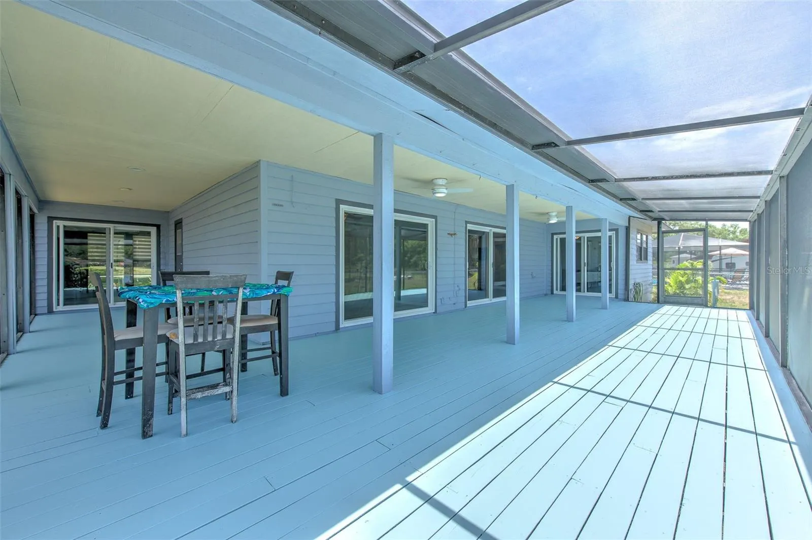 Wrap around covered screened in patio overlooking the lake and backyard