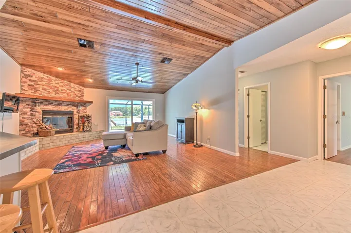 Open concept floor plan. tongue & groove living room ceilings, wood burning fireplace
