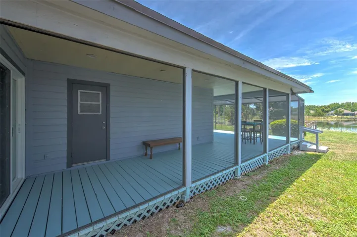 Wrap around covered screened in patio (view of slider door at bedroom 2 and bathroom 2 door)