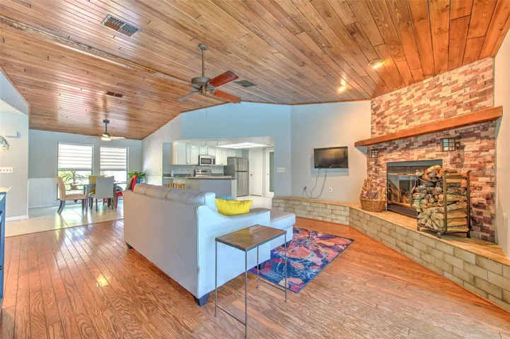 Open concept floor plan. tongue & groove living room ceilings, wood burning fireplace