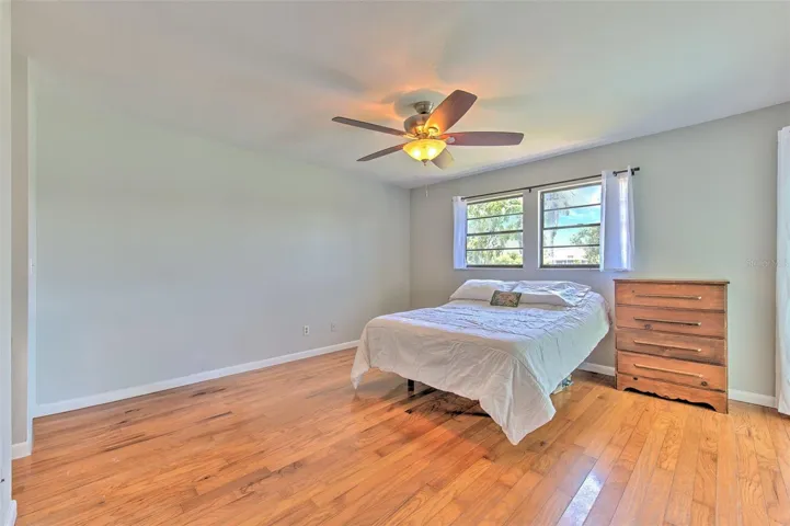 Master Bedroom with Backyard Lake views and slider doors to screened in patio