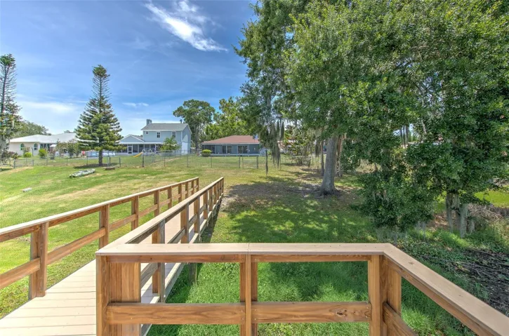 view of back of home from newer dock with handrails