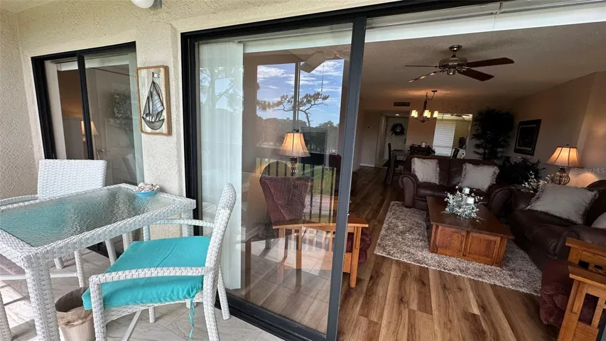 Wall to Wall Spectacular Porch, sliding door entrance to Great Room Sitting Area.