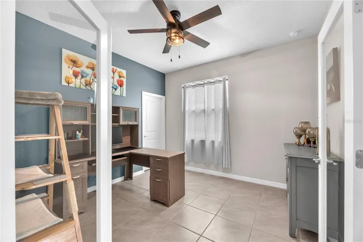 Bedroom #3 has a walk-in closet, ceiling fan, and glass french doors.