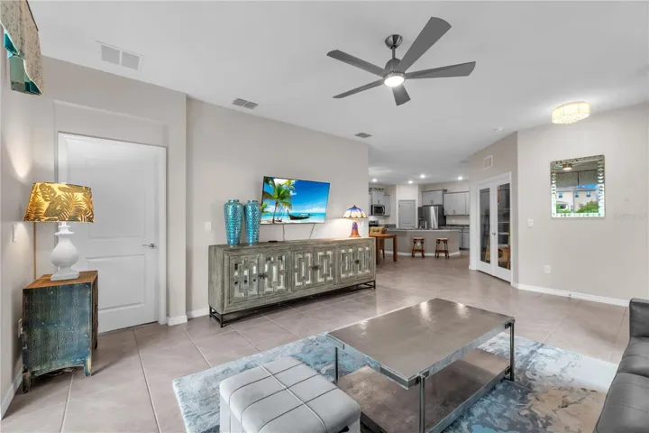 The spacious primary suite is tucked away at the rear of the home off the living room.