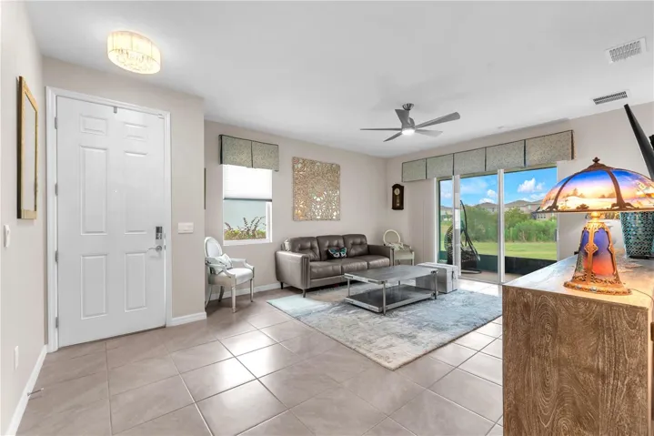 The living room just inside the front door has lots of natural light and buyers will love the window treatments from Ethan Allen.