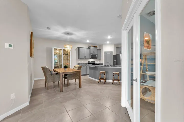 Inside, you'll find a bright and inviting floor plan with abundant natural light, neutral décor, and durable tile flooring throughout the main living areas.