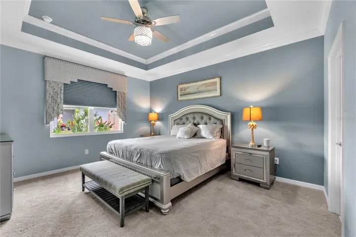 The spacious primary bedroom is a private retreat with a large walk-in closet, stunning tray ceiling and a luxurious en-suite bathroom.