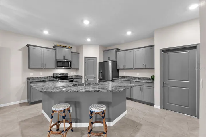 This kitchen has convenient access to the garage and has a large walk-in corner pantry to store all of your kitchen essentials.