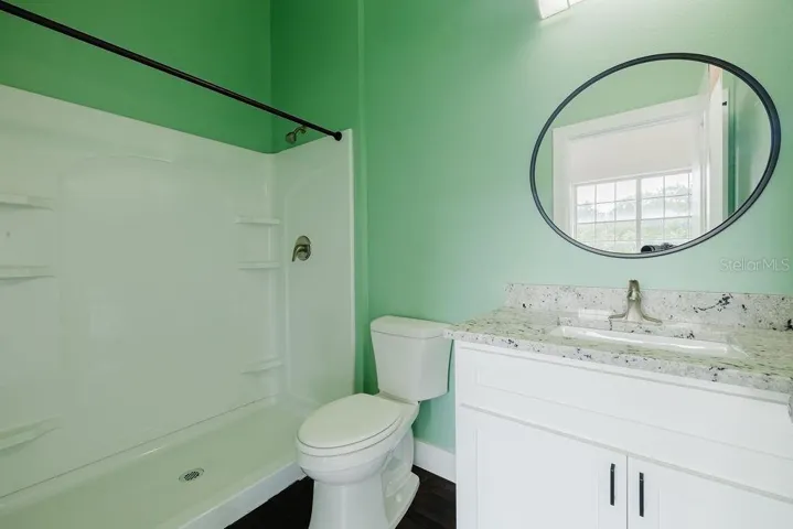 Bathroom with granite vanity and all wood cabinets.