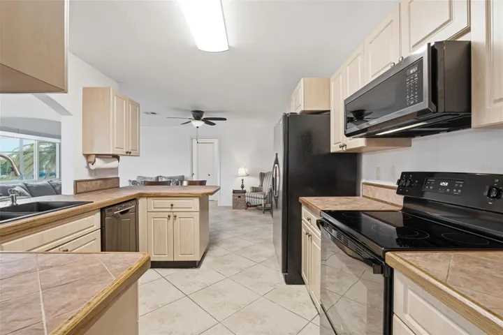 Spacious Kitchen With Breakfast Bar & Open Flow to Living Areas.