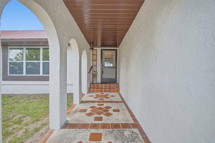 Covered Front Entry with Decorative Tile Flooring.