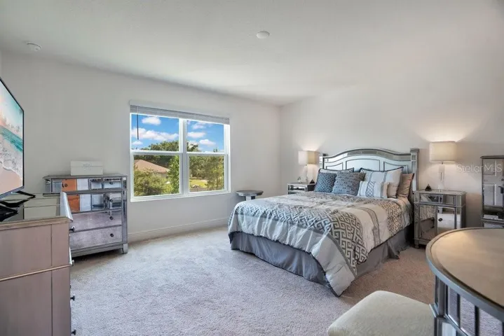 The spacious Primary Suite serves as a private retreat with a walk-in closet and a beautifully appointed SPA-INSPIRED en suite bath.