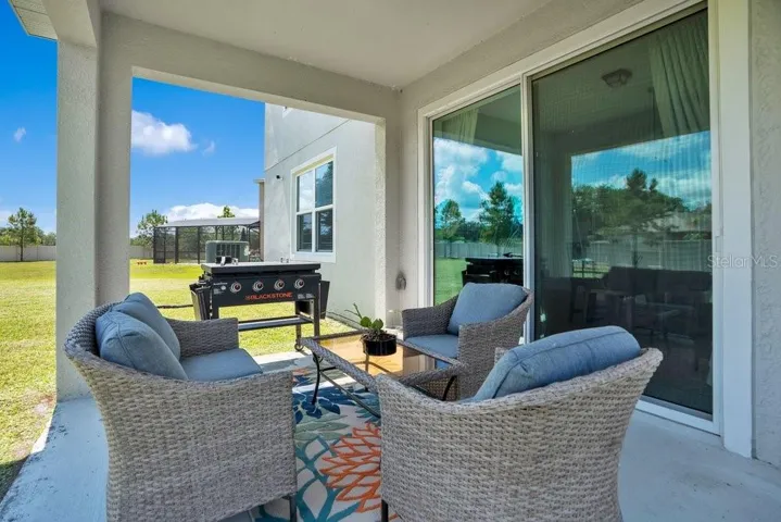 Step outside to the covered patio overlooking the SPACIOUS BACKYARD.
