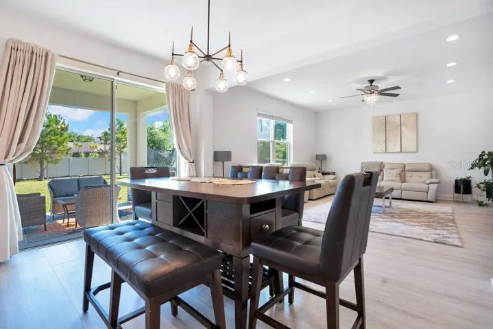 Sliding glass doors in the Dining area flood the space with sunlight and provide views of the EXPANSIVE BACKYARD.