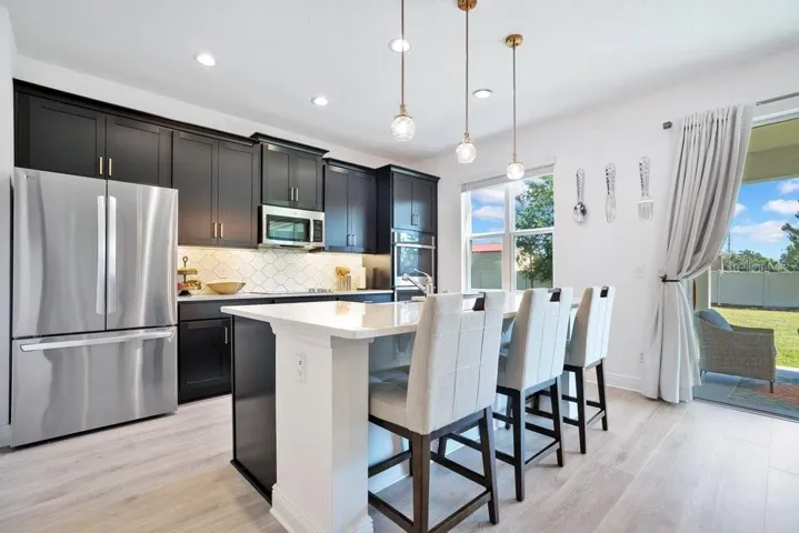 With room for counter-height stools, the center island serves as a comfortable spot for quick meals or gathering with guests.