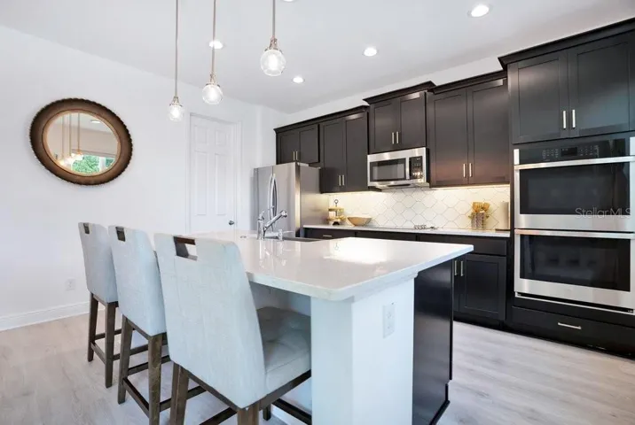 With room for counter-height stools, the center island serves as a comfortable spot for quick meals or gathering with guests.