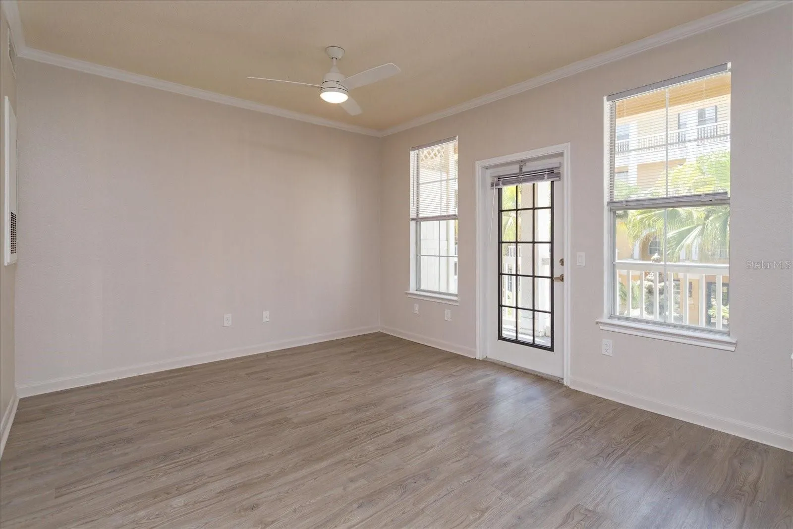 Studio apartment with Laminate Flooring and lots of windows bringing in natural light.  The patio overlooks the courtyard area.