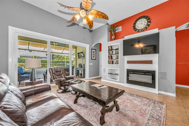 Great Room with electric fireplace and custom storage and access behind