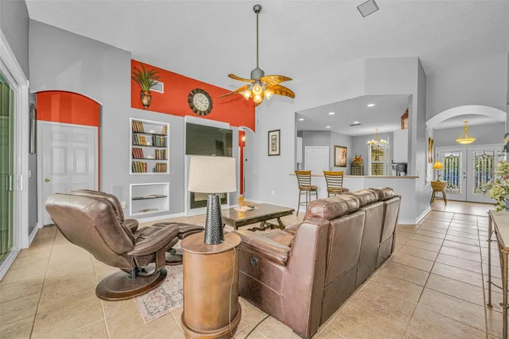 Gracious arches, plant shelves, recessed lighting and lovely architectural details throughout.