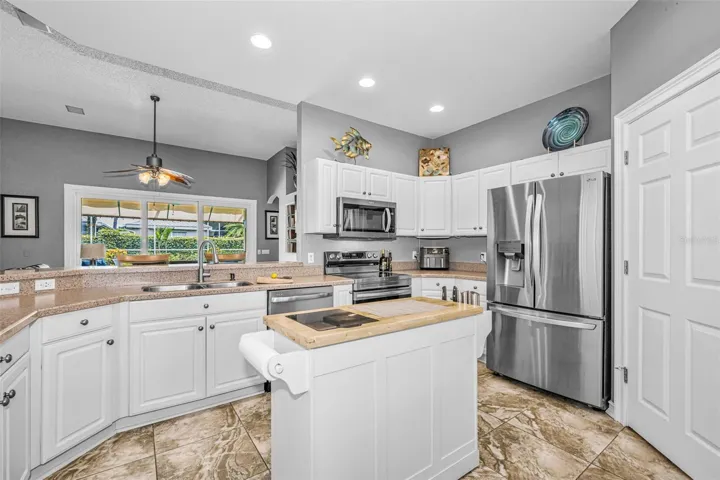 Kitchen overlooks great room with a breakfast bar