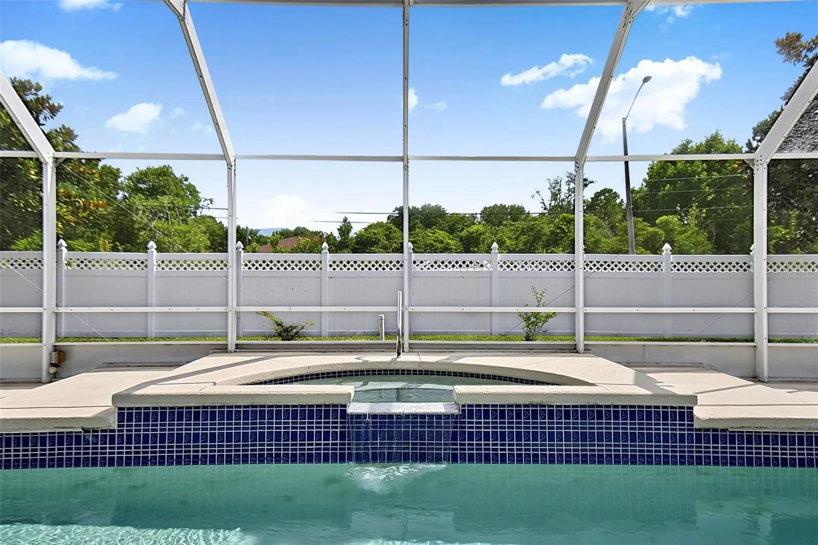 Built in jacuzzi with waterfall into pool
