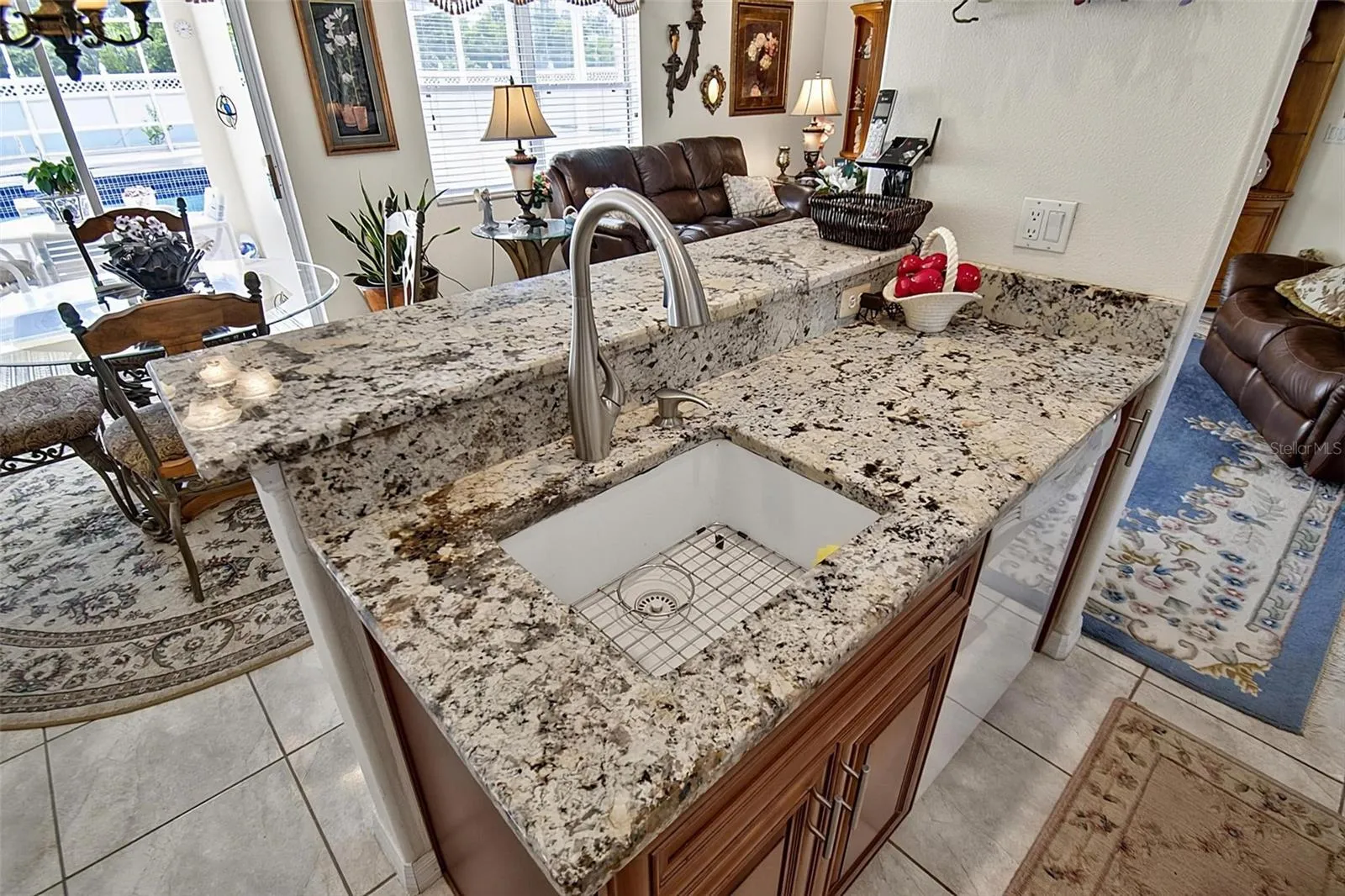 Kitchen sink with view of pool lanai