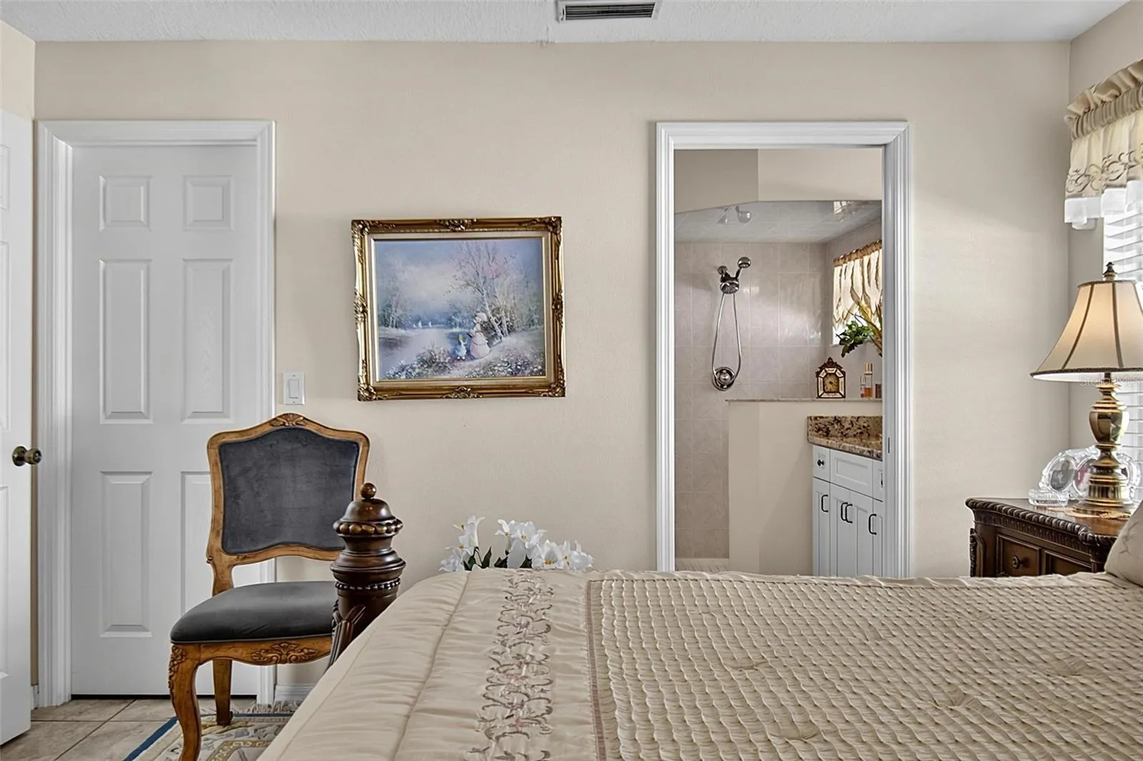 Primary bedroom with view into bathroom and closet