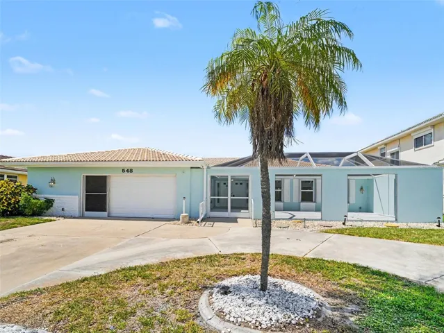 Front of home, large circular drive, expansive screened in court yard